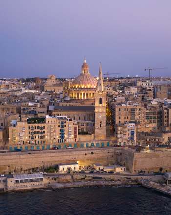Aerial view of the historic skyline of Valletta featuring the Basilica of Our Lady of Mount Carmel and St. Paul s Pro Cathedral in Valletta Port Region Malta. Aerial view of the historic skyline of Valletta featuring the Basilica of Our Lady of Mount Carmel and St. Paul s Pro Cathedral in Valletta Port Region Malta.