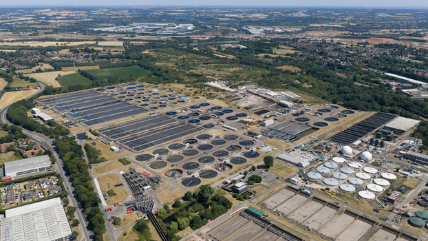 Aerial view of the Severn Trent Water Minworth wastewater treatment plant with circular settling tanks and rectangular basins surrounded by green fields in Birmingham England United Kingdom. Aerial view of the Severn Trent Water Minworth wastewater treatment plant with circular settling tanks and rectangular basins surrounded by green fields in Birmingham England United Kingdom.
