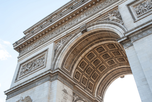View of the Arc de Triomphe showcasing intricate stone carvings classical reliefs and the detailed coffered ceiling under a clear sky in Paris Ile de France France.