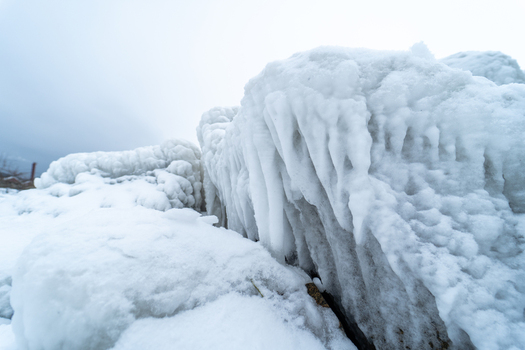 View of ice covered rocks and structures at the Molenfeuer Sassnitz with frozen sea spray and winter conditions in Sassnitz Mecklenburg Vorpommern Germany.