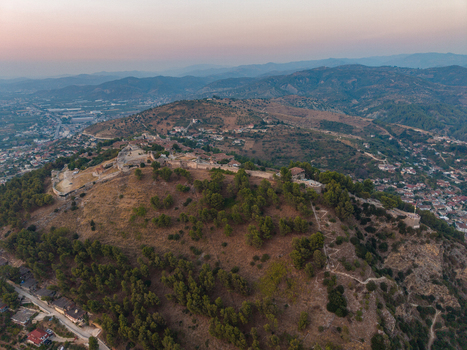 Aerial view of the historic Berat Castle situated on a hill surrounded by lush trees and overlooking the town of Berat Berat Berat County Albania. Aerial view of the historic Berat Castle situated on a hill surrounded by lush trees and overlooking the town of Berat Berat Berat County Albania.