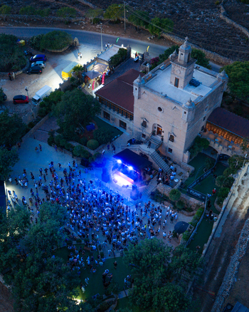 Mgarr Malta 17 September 2026 Aerial view of Castello Zamittello with a crowd of people attending an evening event with a stage and blue lighting in the courtyard. Mgarr Malta 17 September 2026 Aerial view of Castello Zamittello with a crowd of people attending an evening event with a stage and blue lighting in the courtyard.