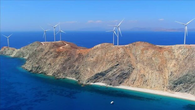 Aerial view of wind turbines on a rocky coastline in Greece. Aerial view of wind turbines on a rocky coastline in Greece.