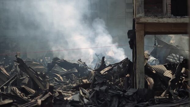 View of smoke rising from debris after a fire in Dhaka Bangladesh. View of smoke rising from debris after a fire in Dhaka Bangladesh.
