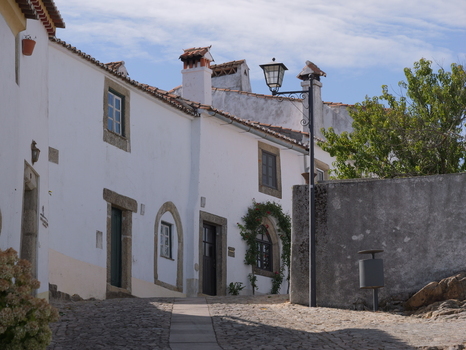 View of the historic white washed stone houses and cobblestone street in the village of Marvao Portalegre District Portugal. View of the historic white washed stone houses and cobblestone street in the village of Marvao Portalegre District Portugal.