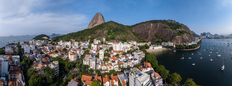 Aerial view of Sugarloaf Mountain and the Urca neighborhood with boats anchored in Guanabara Bay Rio de Janeiro State of Rio de Janeiro Brazil.