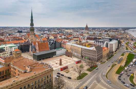 Aerial view of St. Peter s Church spire and Town Hall Square with historic rooftops and the Museum of the Occupation of Latvia in Riga Latvia. Aerial view of St. Peter s Church spire and Town Hall Square with historic rooftops and the Museum of the Occupation of Latvia in Riga Latvia.