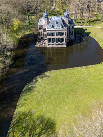 Aerial view of the Oud Poelgeest Castle a historic building reflected in the dark waters of its surrounding moat Oegstgeest Zuid Holland Netherlands. Aerial view of the Oud Poelgeest Castle a historic building reflected in the dark waters of its surrounding moat Oegstgeest Zuid Holland Netherlands.