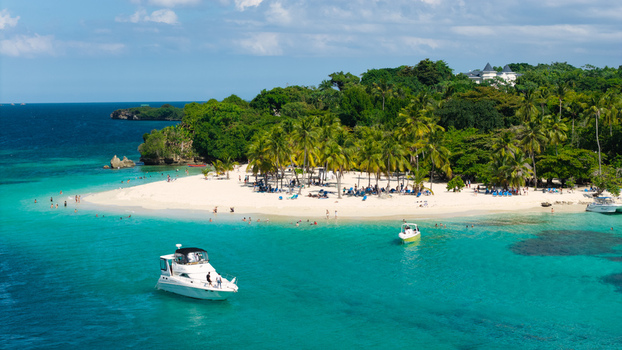 Aerial view of Cayo Levantado Beach with white sand turquoise water palm trees and boats in Samana Samana Dominican Republic. Aerial view of Cayo Levantado Beach with white sand turquoise water palm trees and boats in Samana Samana Dominican Republic.