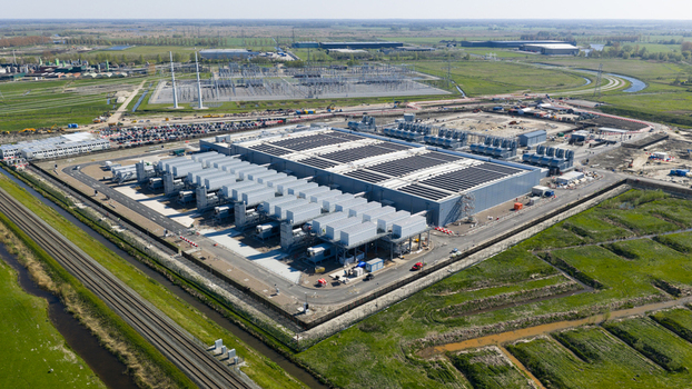 Aerial view of the Datacenter Westpoort facility with cooling systems and industrial infrastructure surrounded by green fields in Groningen Groningen Netherlands. Aerial view of the Datacenter Westpoort facility with cooling systems and industrial infrastructure surrounded by green fields in Groningen Groningen Netherlands.