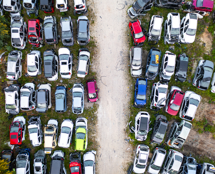 Aerial view of a car junk yard with numerous wrecked and salvaged vehicles parked in organized rows on dirt ground in Petah Tikva Center District Israel. Aerial view of a car junk yard with numerous wrecked and salvaged vehicles parked in organized rows on dirt ground in Petah Tikva Center District Israel.