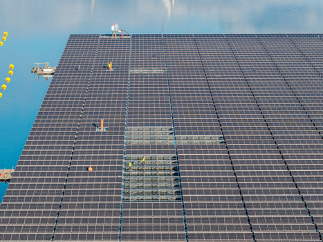 Aerial view of the floating solar panel array on Cottbuser Ostsee undergoing repairs by workers after storm damage in Cottbus Brandenburg Germany. Aerial view of the floating solar panel array on Cottbuser Ostsee undergoing repairs by workers after storm damage in Cottbus Brandenburg Germany.