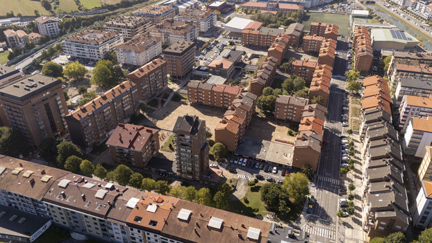 Aerial view of residential apartment buildings with terracotta roofs streets and green spaces in the town of Zumaia Basque Country Spain.