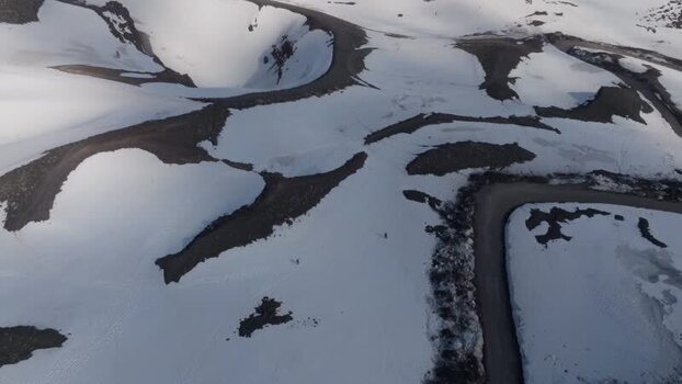 Aerial view of winding roads on the snowy slopes of Mount Etna Italy. Aerial view of winding roads on the snowy slopes of Mount Etna Italy.