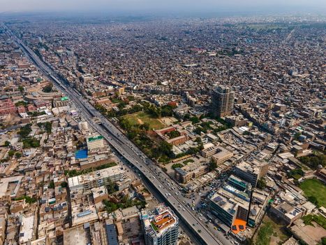 Aerial view of Bala Hisar Fort surrounded by the dense urban landscape bustling roads and historic architecture of Peshawar Khyber Pakhtunkhwa Pakistan.