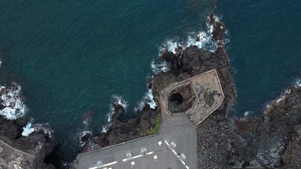 Aerial view of rocky volcanic coastline and concrete platform Italy. Aerial view of rocky volcanic coastline and concrete platform Italy.