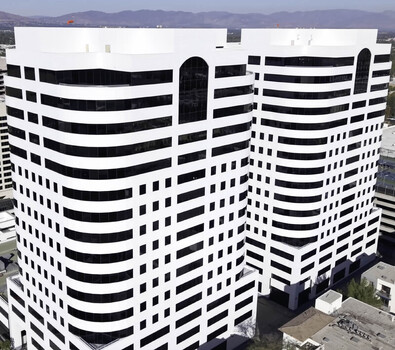 Aerial view of modern office towers featuring a distinctive white and black geometric facade in Los Angeles California United States.