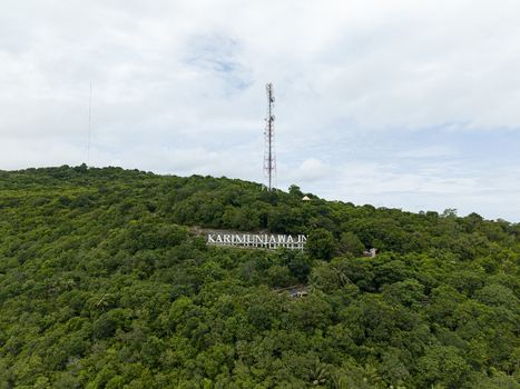 Aerial view of lush green hill displaying the name Karimunjawa under a cloudy sky Karimunjawa Central Java Indonesia. Aerial view of lush green hill displaying the name Karimunjawa under a cloudy sky Karimunjawa Central Java Indonesia.