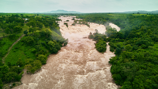 Aerial view of the powerful Gurara Waterfalls cascading through lush green vegetation and dense forest landscape Lambata Niger Nigeria. Aerial view of the powerful Gurara Waterfalls cascading through lush green vegetation and dense forest landscape Lambata Niger Nigeria.