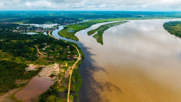 Aerial view of the Cross River flowing through the lush green landscape and rural settlements of Itu Akwa Ibom Nigeria. Aerial view of the Cross River flowing through the lush green landscape and rural settlements of Itu Akwa Ibom Nigeria.
