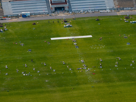 Berlin Berlin Germany 26 September 2026 Aerial view of Olympiastadion Berlin pitch with maintenance equipment and markings on the green grass.