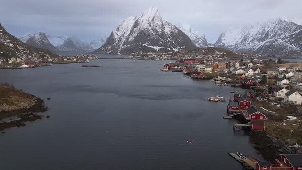 Aerial view of Lofoten village with snow capped mountains Norway.