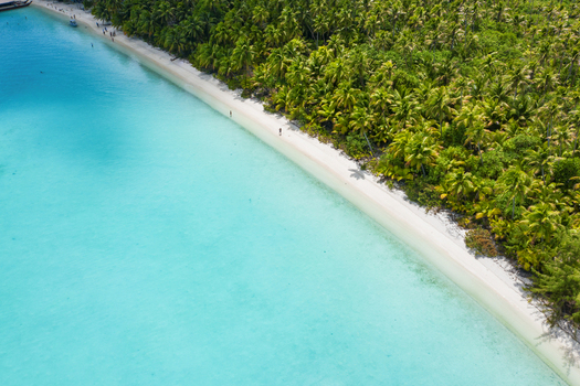 Aerial view of Aitutaki One Foot Island featuring a pristine white sand beach bordered by lush palm trees and vibrant turquoise lagoon waters Arutanga Cook Islands. Aerial view of Aitutaki One Foot Island featuring a pristine white sand beach bordered by lush palm trees and vibrant turquoise lagoon waters Arutanga Cook Islands.