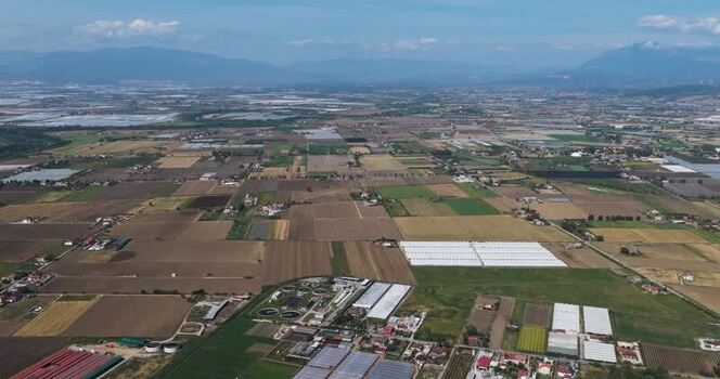 Aerial view of agricultural fields and greenhouses Italy.
