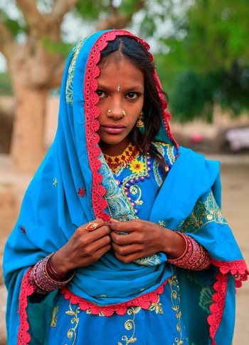 Rahim Yar Khan Pakistan 11 November 2015 View of a young girl wearing a traditional blue headscarf and ornate jewelry during Diwali celebrations.