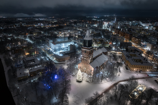 Aerial view of Turku Cathedral illuminated at night surrounded by snow covered parkland and the historic cityscape of Turku Varsinais Suomi Finland. Aerial view of Turku Cathedral illuminated at night surrounded by snow covered parkland and the historic cityscape of Turku Varsinais Suomi Finland.