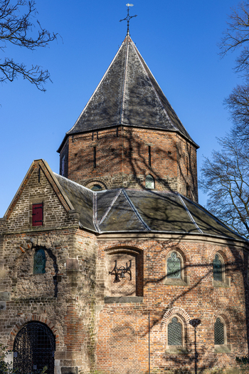 View of the historic Sint Nicolaaskapel with its distinctive brickwork and conical roof under a clear blue sky in Nijmegen Gelderland Netherlands. View of the historic Sint Nicolaaskapel with its distinctive brickwork and conical roof under a clear blue sky in Nijmegen Gelderland Netherlands.