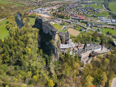 Aerial view of Orava Castle perched on a high rock cliff above the Orava river surrounded by lush green forests and the town of Dolny Kubin Zilinsky kraj Slovakia. Aerial view of Orava Castle perched on a high rock cliff above the Orava river surrounded by lush green forests and the town of Dolny Kubin Zilinsky kraj Slovakia.