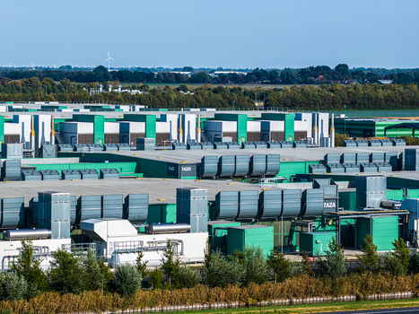 Aerial view of Agriport A7 data center complex with large industrial buildings green and grey facades and ventilation units in Middenmeer Noord Holland Netherlands. Aerial view of Agriport A7 data center complex with large industrial buildings green and grey facades and ventilation units in Middenmeer Noord Holland Netherlands.