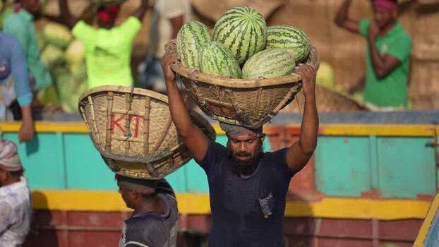 View of workers carrying watermelons at Sadarghat Bangladesh.