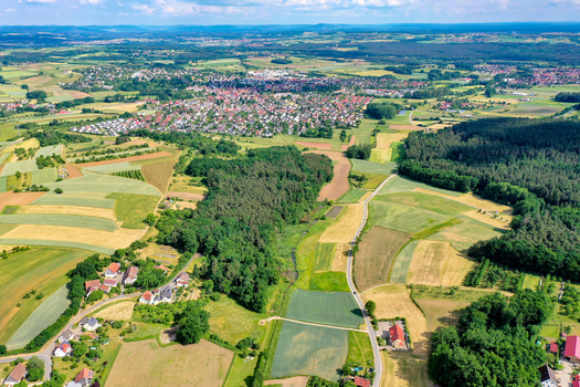 Aerial view of the town nestled among vibrant green fields agricultural patches and dense forests Neunkirchen am Brand Bavaria Germany. Aerial view of the town nestled among vibrant green fields agricultural patches and dense forests Neunkirchen am Brand Bavaria Germany.