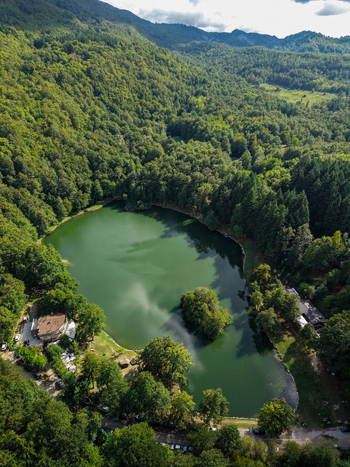 Aerial view of Lago Pontini surrounded by dense forests and rolling hills in Bagno di Romagna Emilia Romagna Italy. Aerial view of Lago Pontini surrounded by dense forests and rolling hills in Bagno di Romagna Emilia Romagna Italy.