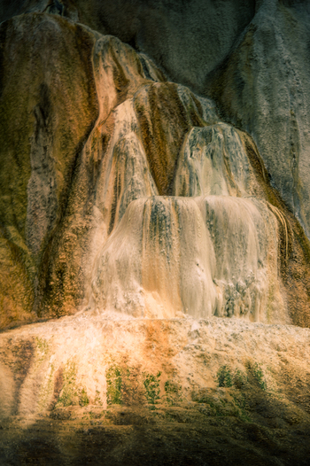 View of travertine terrace formations with mineral deposits at Mammoth Hot Springs in Yellowstone National Park United States.