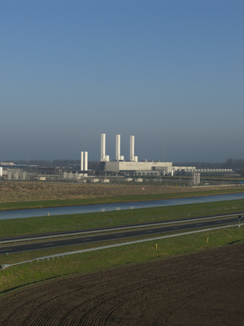 Aerial view of the nitrogen plant with tall white chimneys a canal and a highway running through agricultural fields in Zuidbroek Groningen Netherlands. Aerial view of the nitrogen plant with tall white chimneys a canal and a highway running through agricultural fields in Zuidbroek Groningen Netherlands.