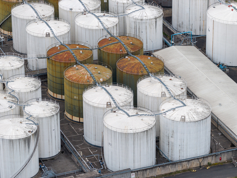 Aerial view of TanQuid Tanklager Berlin featuring large cylindrical industrial storage tanks with metal walkways and weathered surfaces in Berlin Berlin Germany.