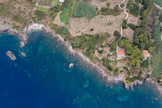 Aerial view of the Riserva Naturale Orientata dello Zingaro coastline with rugged cliffs turquoise sea Mediterranean vegetation and a secluded villa in San Vito Lo Capo Sicilia Italy. Aerial view of the Riserva Naturale Orientata dello Zingaro coastline with rugged cliffs turquoise sea Mediterranean vegetation and a secluded villa in San Vito Lo Capo Sicilia Italy.
