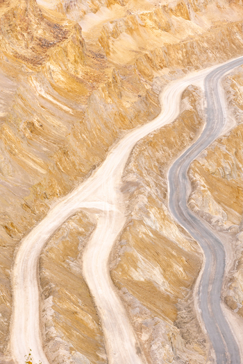 Geamana Romania 21 September 2026 Aerial view of the winding dirt roads and steep terraced slopes of the Geamana mining site with its distinctive yellow and grey earth textures. Geamana Romania 21 September 2026 Aerial view of the winding dirt roads and steep terraced slopes of the Geamana mining site with its distinctive yellow and grey earth textures.