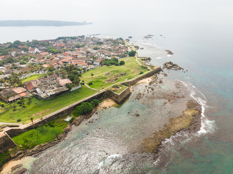 Aerial view of the historic Galle Fort with its stone ramparts green lawns and colonial architecture along the rocky coastline in Galle Southern Province Sri Lanka. Aerial view of the historic Galle Fort with its stone ramparts green lawns and colonial architecture along the rocky coastline in Galle Southern Province Sri Lanka.