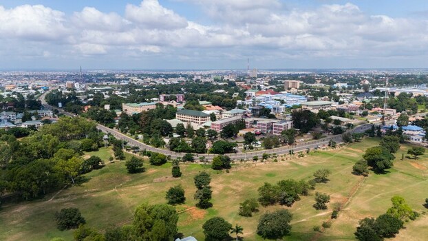 Aerial view of the city blending lush green spaces with the urban sprawl under a vast cloudy sky Kaduna Kaduna Nigeria.