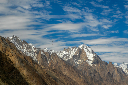 View of the snow capped peaks of the Trango Towers in the Karakoram mountain range under a blue sky with wispy clouds Pakistan. View of the snow capped peaks of the Trango Towers in the Karakoram mountain range under a blue sky with wispy clouds Pakistan.