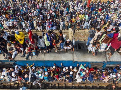Tongi Bangladesh 04 February 2024 Aerial view of Tongi Junction crowded with thousands of people sitting on the roof of a train and standing on the platform. Tongi Bangladesh 04 February 2024 Aerial view of Tongi Junction crowded with thousands of people sitting on the roof of a train and standing on the platform.