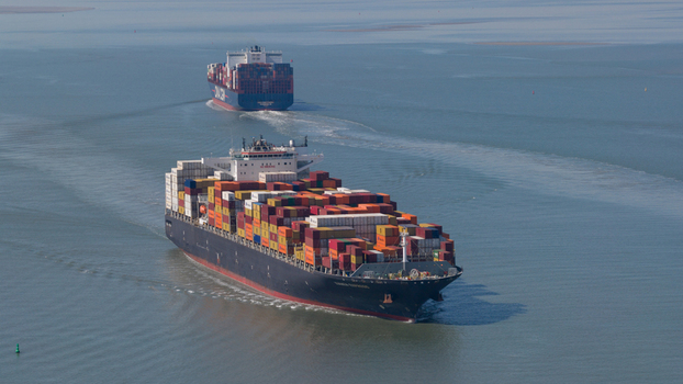 Terneuzen Netherlands 08 April 2026 Aerial view of two large container ships loaded with colorful cargo sailing through the calm waters of the Western Scheldt estuary. Terneuzen Netherlands 08 April 2026 Aerial view of two large container ships loaded with colorful cargo sailing through the calm waters of the Western Scheldt estuary.