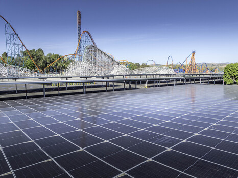 Los Angeles County United States 08 April 2026 Aerial view of Six Flags Magic Mountain roller coasters behind a large solar panel array under a clear blue sky. Los Angeles County United States 08 April 2026 Aerial view of Six Flags Magic Mountain roller coasters behind a large solar panel array under a clear blue sky.