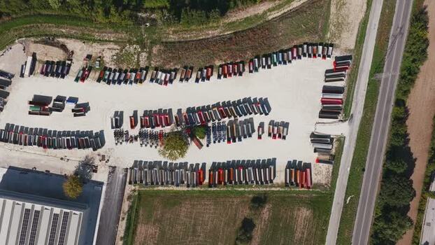 Aerial view of industrial truck trailer parking lot in Italy.