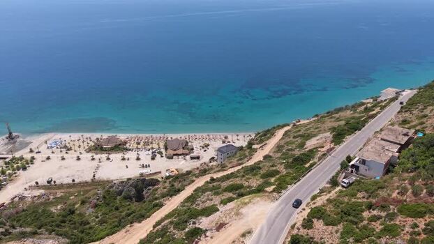 Aerial view of coastal road and beach in Himare Albania.