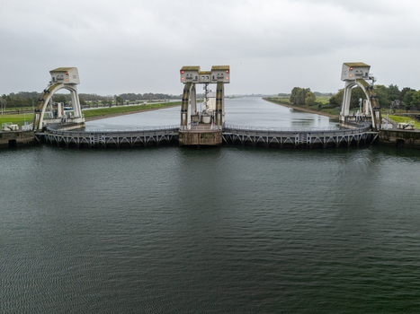 Aerial view of the Sluis en stuwcomplex Hagestein a historic weir and lock complex spanning the Lek River with concrete structures and calm water in Hagestein Utrecht Netherlands.
